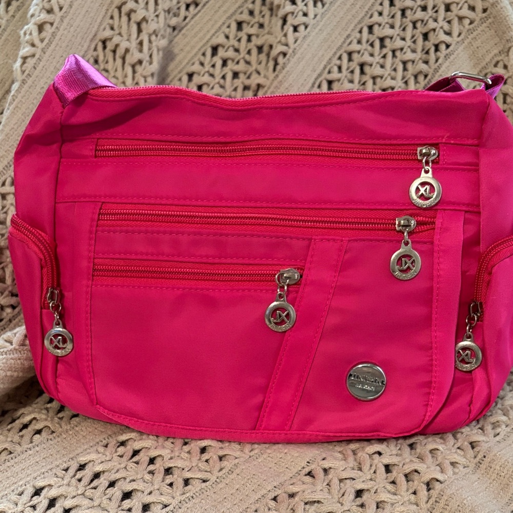 Vibrant Pink Crossbody Bag with Silver Accents and Adjustable Strap